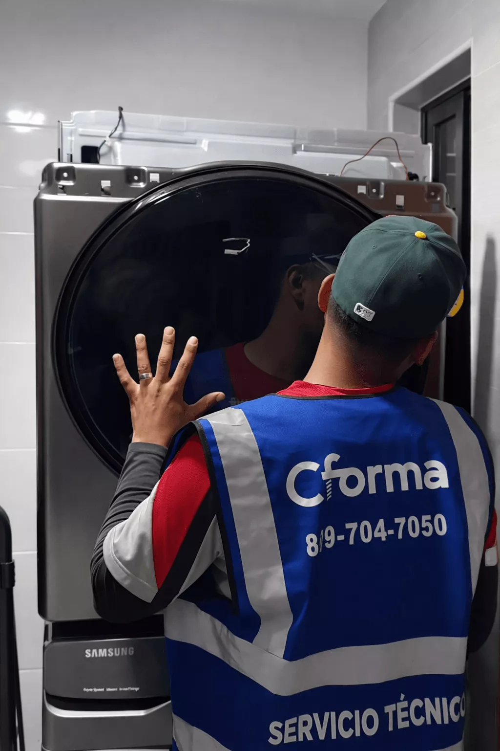 CForma technician performing an appliance repair during a service call